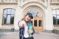 Portrait of a happy student with books and notebooks in the hands of the university building background Royalty Free Stock Photo