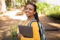 Portrait of happy student lady with laptop and backpack outdoors Royalty Free Stock Photo