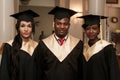 Portrait of happy students in graduation gowns Royalty Free Stock Photo