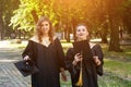 Portrait of happy students in graduation gowns Royalty Free Stock Photo