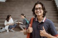 Portrait happy students holding bag and showing thumbs Royalty Free Stock Photo