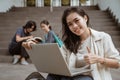 Portrait happy students holding laptops and showing thumbs Royalty Free Stock Photo