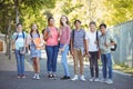 Portrait of happy students standing with books on road Royalty Free Stock Photo