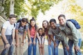 Portrait of happy students standing with books on road Royalty Free Stock Photo