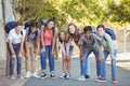 Portrait of happy students standing with schoolbag on road Royalty Free Stock Photo