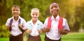 Composite image of portrait of happy students in uniforms Royalty Free Stock Photo