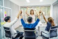 Portrait Of Happy Successful Business Group at office,.Business team celebrating a triumph with arms up,