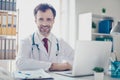 Portrait of happy successful doctor in glasses sitting at the de Royalty Free Stock Photo