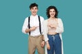 Portrait of happy successful two brunette stylish partner, couple or friends standing and pointing each other and looking at Royalty Free Stock Photo