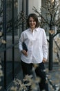 Portrait of happy successful woman in white shirt and black trousers. Business woman in classic closes