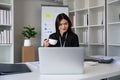 Portrait of happy and successful young Asian business woman employee in modern office Royalty Free Stock Photo