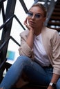 Portrait of sucessful woman on steel stairs at back yard. Royalty Free Stock Photo