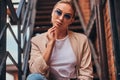 Portrait of sucessful woman on steel stairs at back yard. Royalty Free Stock Photo