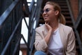 Portrait of happy sucessful woman on steel stairs at back yard. Royalty Free Stock Photo