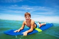 Portrait of happy surfing boy lay on surfboard Royalty Free Stock Photo