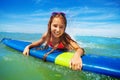 Portrait of happy surfing girl lay on surfboard Royalty Free Stock Photo