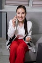 portrait of happy, surprised, excited brunette business woman talking by phone in gray office. gain, good phone call Royalty Free Stock Photo