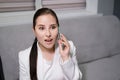 portrait of happy, surprised, excited brunette business woman talking by phone in gray office. gain, good phone call Royalty Free Stock Photo