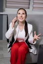 portrait of happy, surprised, excited brunette business woman talking by phone in gray office. gain, good phone call Royalty Free Stock Photo