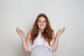 Portrait of happy surprised woman shacking her hands on white background