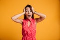 Portrait of happy surprised young woman in red dress standing wi Royalty Free Stock Photo