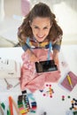 Portrait of happy tailor woman using tablet pc