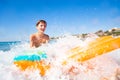 Happy boy with air mattress having fun in the sea Royalty Free Stock Photo