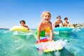 Happy boy riding the waves with his friends Royalty Free Stock Photo