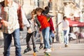 Happy teen skateboarding with friends at side walk Royalty Free Stock Photo