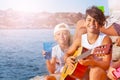 Young musician plays guitar at outing with friends Royalty Free Stock Photo