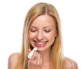 Portrait of happy teenage girl applying hygienic lipstick Royalty Free Stock Photo