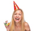 Portrait of happy teenage girl in cap with party horn blower Royalty Free Stock Photo