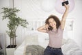 Portrait of happy teenage girl listening to music and dancing Royalty Free Stock Photo