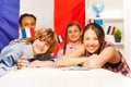 Portrait of happy teenage students holding flags Royalty Free Stock Photo