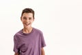 Portrait of happy teenaged disabled boy with cerebral palsy smiling at camera, posing isolated over white background Royalty Free Stock Photo