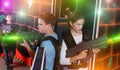 Girl and boy playing laser tag Royalty Free Stock Photo