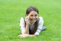 Portrait of happy teener girl adjusting glasses lying on grass after school, girl. Teen girl Royalty Free Stock Photo