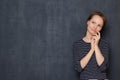 Portrait of happy thoughtful young woman touching face with hand Royalty Free Stock Photo