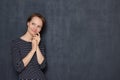 Portrait of happy thoughtful young woman touching face with hand Royalty Free Stock Photo