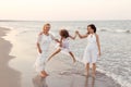 Portrait of three generations of women standing at beach holding hands Royalty Free Stock Photo