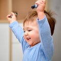 Portrait of a happy toddler baby boy with his hands up. The face of a s Royalty Free Stock Photo