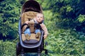 Portrait of a happy toddler baby boy in a stroller, a child in nature Royalty Free Stock Photo