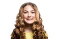 Portrait of happy toothy smiley girl with wavy hairstyle and yellow t shirt.