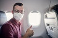 Portrait of happy tourist with face mask during flight