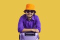 Portrait of happy tourist in summer hat and sunglasses leaning on suitcase and smiling Royalty Free Stock Photo