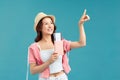 Portrait of happy tourist woman holding passport