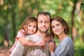 Portrait of a happy traditional family on walk in a summer park