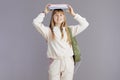 Portrait of happy trendy school girl in beige tracksuit Royalty Free Stock Photo