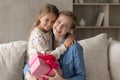 Portrait of happy two generations family posing with gift box. Royalty Free Stock Photo