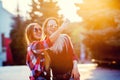 Portrait of a happy two smiling girls making selfie photo on smartphone. urban background. The evening sunset over the Royalty Free Stock Photo
